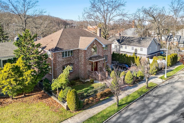 64-16 211th St, Bayside, NY 11364 - view of front of home with a chimney, brick siding, a shingled roof, and a residential view