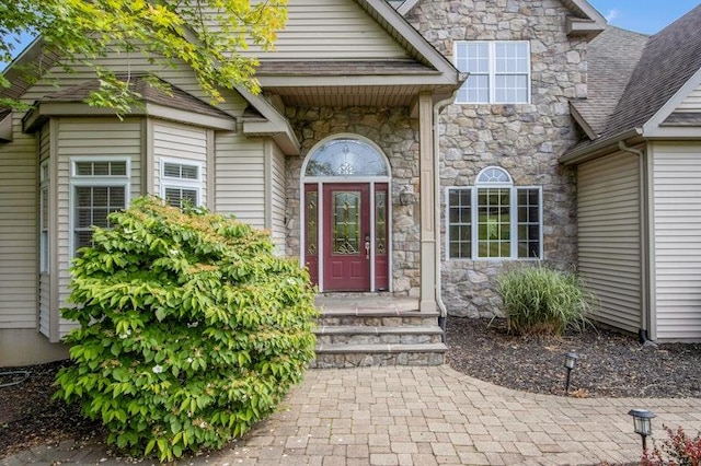 32 Gellatly Dr, Wappingers Falls, NY 12590 - property entrance with stone siding and roof with shingles