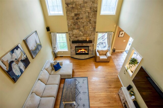 32 Gellatly Dr, Wappingers Falls, NY 12590 - living room featuring a high ceiling, plenty of natural light, a fireplace, and wood finished floors