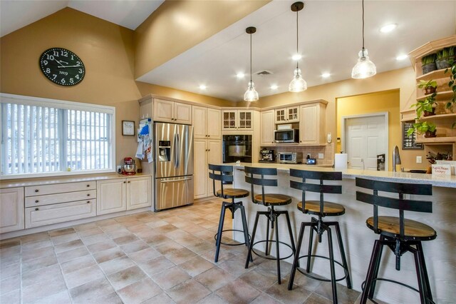 32 Gellatly Dr, Wappingers Falls, NY 12590 - kitchen with stainless steel appliances, light countertops, a breakfast bar, decorative backsplash, and high vaulted ceiling