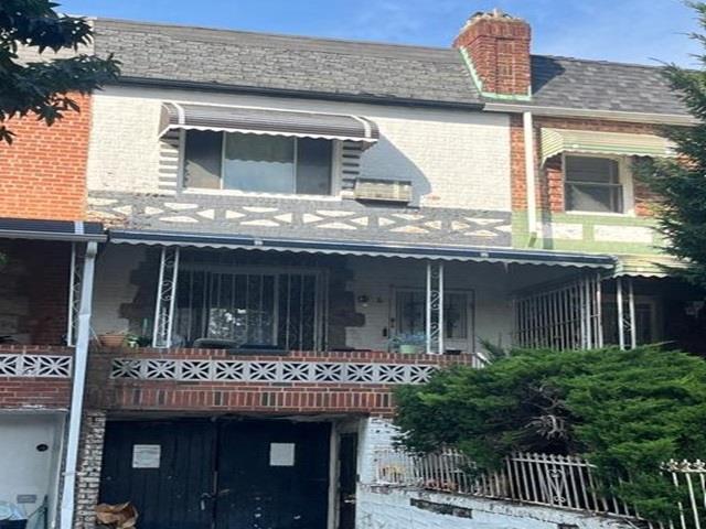 6 E 55th St, Brooklyn, NY 11203 - view of front of house with brick siding, a balcony, a chimney, and a garage