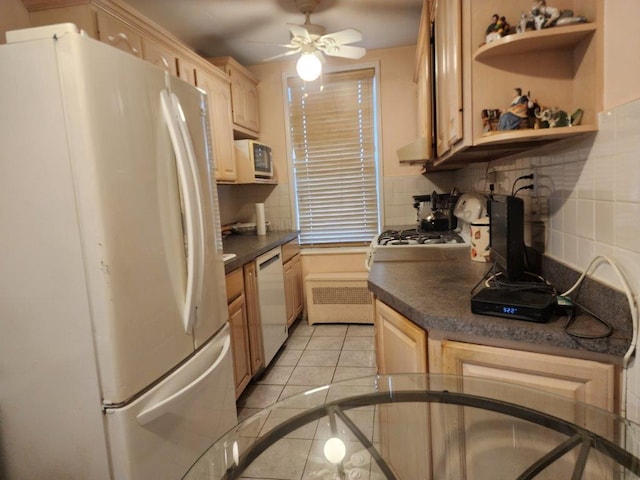 2251 Plumb 1st St Unit 6B, Brooklyn, NY 11229 - kitchen with white appliances, backsplash, light brown cabinets, dark countertops, and light tile patterned flooring
