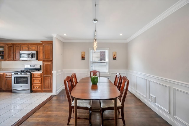 189 Stanton Blvd, Uniondale, NY 11553 - dining area featuring recessed lighting, ornamental molding, wainscoting, and wood finished floors