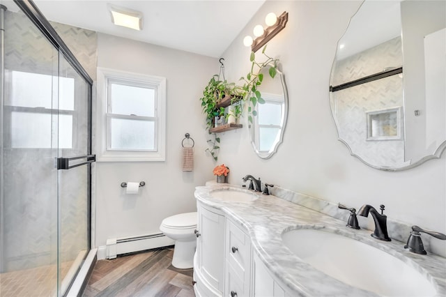189 Stanton Blvd, Uniondale, NY 11553 - bathroom featuring a baseboard radiator, a stall shower, double vanity, and wood finished floors