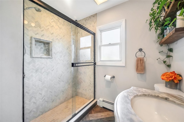 189 Stanton Blvd, Uniondale, NY 11553 - bathroom with a baseboard radiator, a stall shower, and wood finished floors