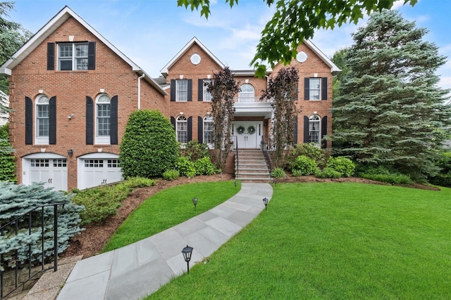 41 Carlton Dr, Mount Kisco, NY 10549 - colonial home featuring brick siding, a front lawn, and an attached garage