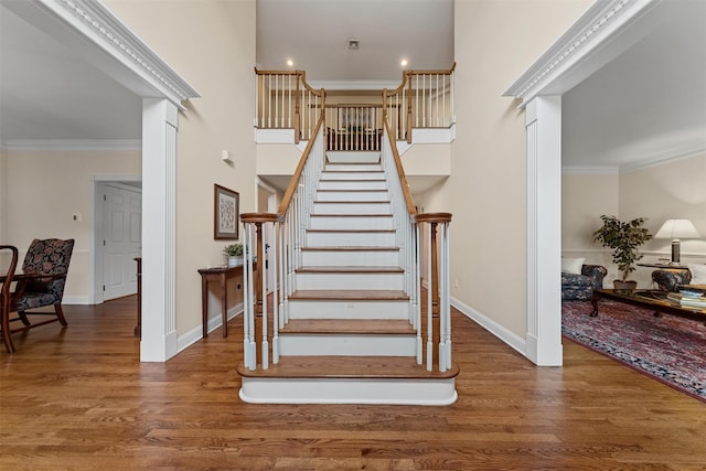 41 Carlton Dr, Mount Kisco, NY 10549 - stairway with wood finished floors, ornamental molding, and a high ceiling