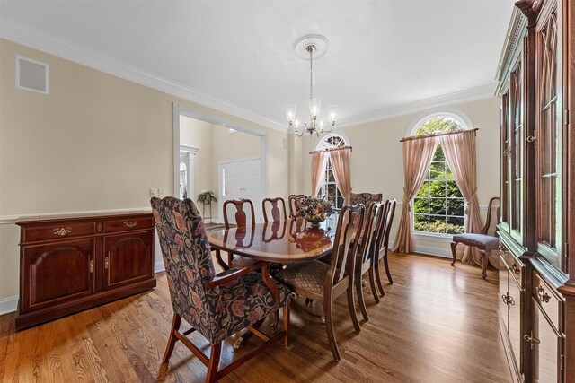 41 Carlton Dr, Mount Kisco, NY 10549 - dining space with light wood-style flooring, a chandelier, and ornamental molding