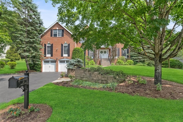 41 Carlton Dr, Mount Kisco, NY 10549 - view of front of house with driveway, an attached garage, a front yard, and brick siding