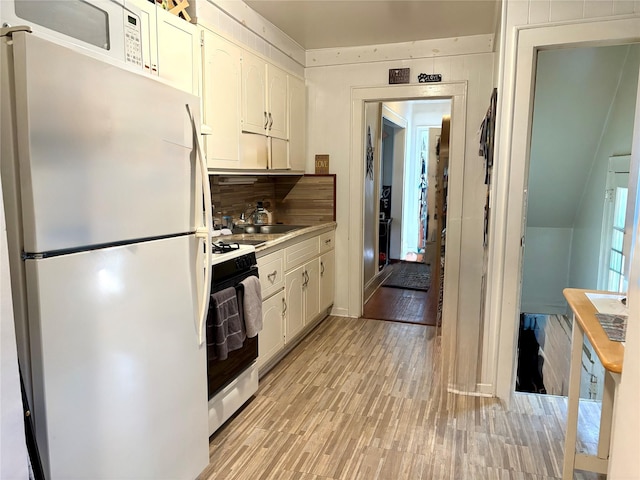 44 Waldo Ave, East Rockaway, NY 11518 - kitchen with white appliances, white cabinets, decorative backsplash, and light countertops