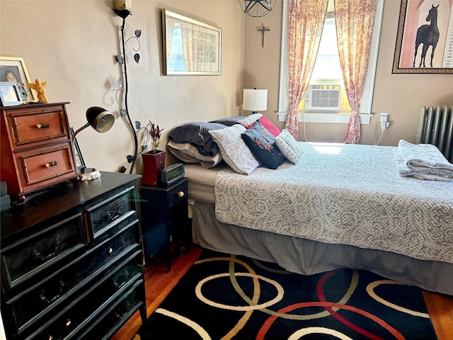 44 Waldo Ave, East Rockaway, NY 11518 - bedroom featuring wood finished floors, radiator, and cooling unit