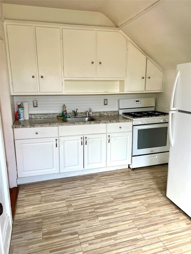 44 Waldo Ave, East Rockaway, NY 11518 - kitchen featuring white appliances, white cabinets, vaulted ceiling, and light wood-style flooring