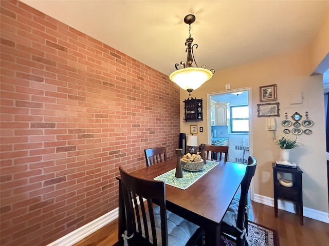 143-50 Hoover Ave Unit 302, Bayside, NY 11435 - dining room featuring brick wall, dark wood-type flooring, and radiator