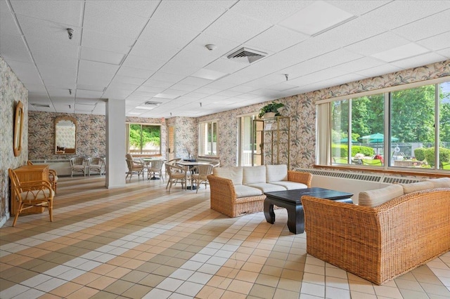 1270 N Ave Unit 5A, New Rochelle, NY 10804 - living area with wallpapered walls, light tile patterned flooring, and a drop ceiling