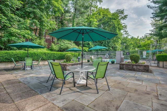 1270 N Ave Unit 5A, New Rochelle, NY 10804 - view of patio featuring outdoor dining space and view of wooded area