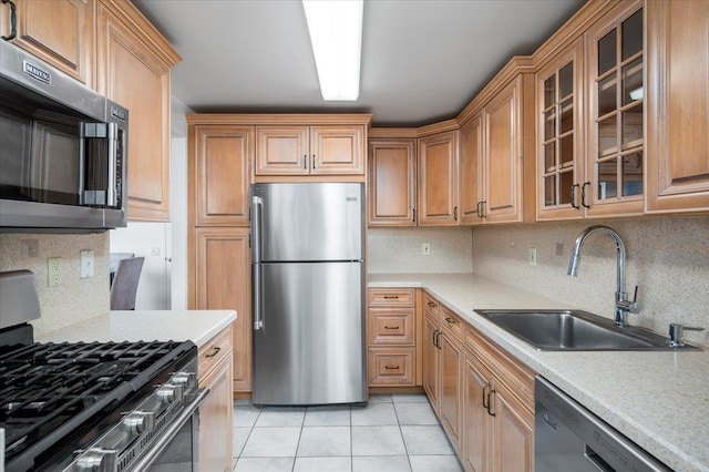 1270 N Ave Unit 5A, New Rochelle, NY 10804 - kitchen featuring appliances with stainless steel finishes, backsplash, light tile patterned floors, and light countertops