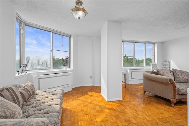 1270 N Ave Unit 5A, New Rochelle, NY 10804 - living area with a textured ceiling and baseboards