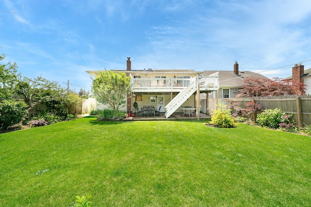 255 Rose St, Copiague, NY 11726 - rear view of property featuring a fenced backyard, stairs, a deck, and a patio area