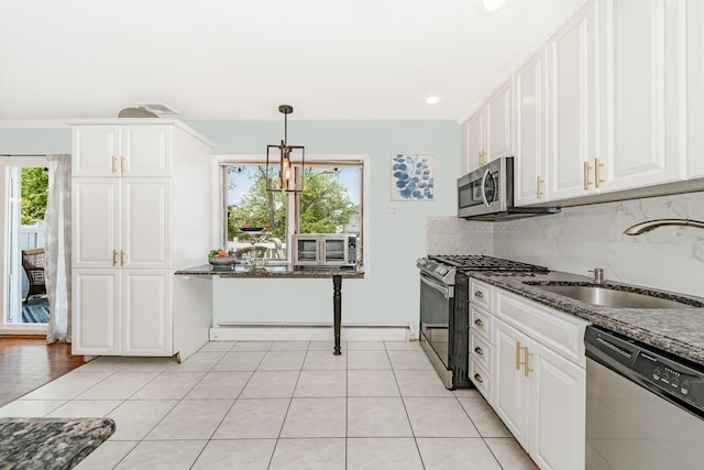 255 Rose St, Copiague, NY 11726 - kitchen with stainless steel appliances, white cabinets, dark stone counters, backsplash, and recessed lighting