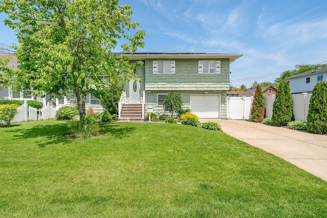 255 Rose St, Copiague, NY 11726 - split foyer home with concrete driveway and an attached garage