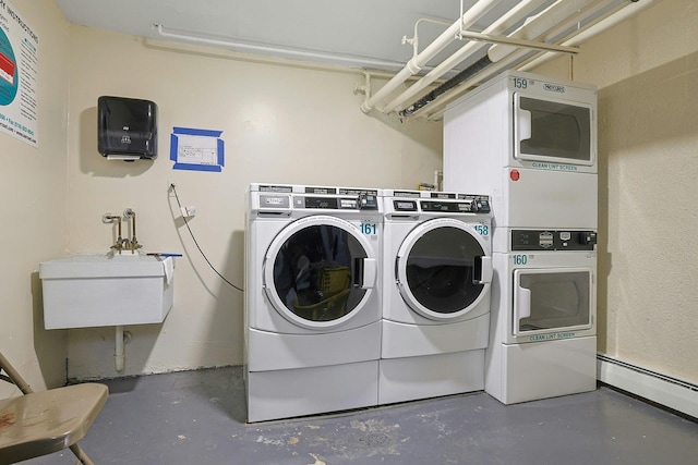 13 Darian Ct Unit 2B, Pomona, NY 10970 - shared laundry room with washing machine and clothes dryer, a baseboard heating unit, and estacked washer and dryer