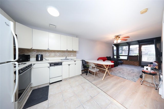 1205 65th St Unit A, Brooklyn, NY 11219 - kitchen with white appliances, a ceiling fan, light countertops, white cabinets, and decorative backsplash
