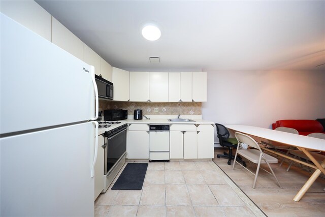 1205 65th St Unit A, Brooklyn, NY 11219 - kitchen featuring white appliances, light countertops, backsplash, light tile patterned floors, and white cabinets