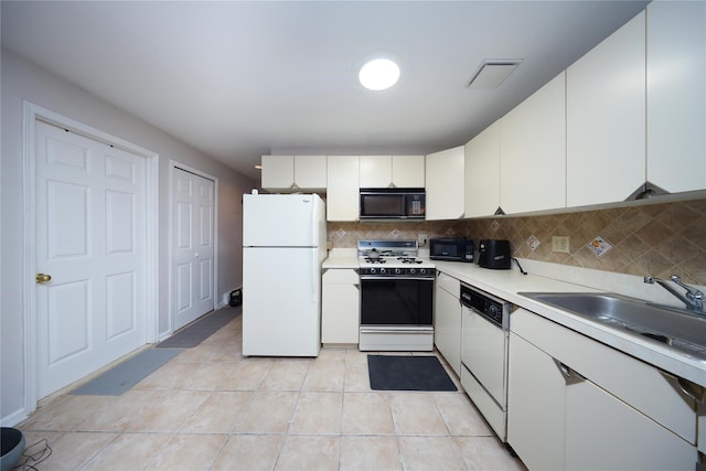 1205 65th St Unit A, Brooklyn, NY 11219 - kitchen with white appliances, light countertops, backsplash, and white cabinets