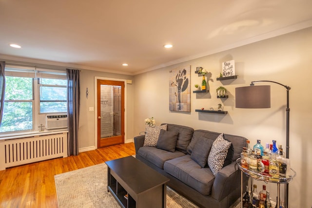 192-1239th Ave 1, Flushing, NY 11358 - living room with radiator heating unit, wood finished floors, ornamental molding, recessed lighting, and cooling unit