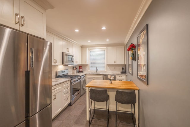 192-1239th Ave 1, Flushing, NY 11358 - kitchen featuring stainless steel appliances, crown molding, wood counters, tasteful backsplash, and white cabinets