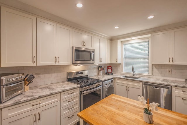 192-1239th Ave 1, Flushing, NY 11358 - kitchen featuring stainless steel appliances, washer / clothes dryer, white cabinets, wood counters, and recessed lighting