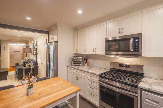 192-1239th Ave 1, Flushing, NY 11358 - kitchen featuring stainless steel appliances, backsplash, white cabinetry, wood counters, and recessed lighting