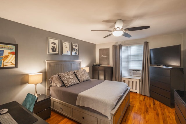 192-1239th Ave 1, Flushing, NY 11358 - bedroom featuring radiator, wood finished floors, cooling unit, and a ceiling fan