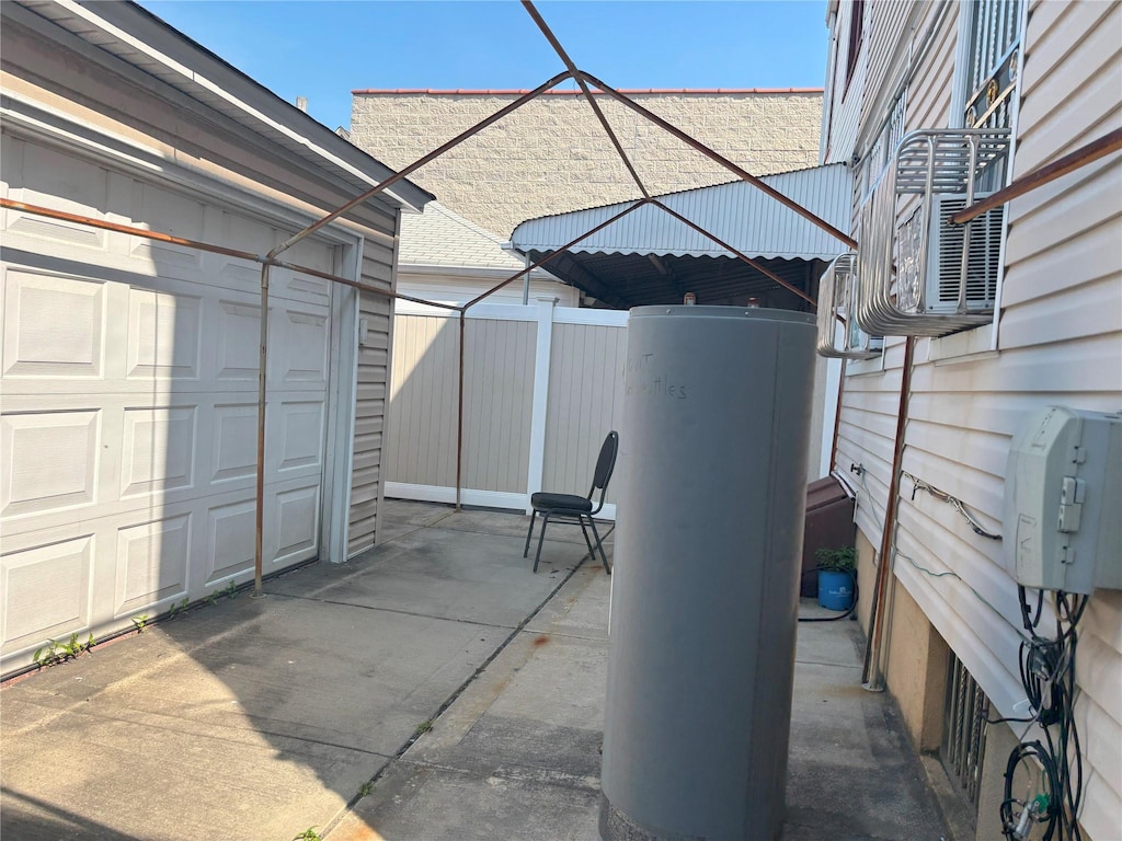 104-16 103rd St, Richmond Hill, NY 11419 - view of patio / terrace featuring a garage