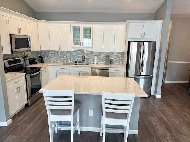 310 Narragansett Villas Dr, Lindenhurst, NY 11757 - kitchen featuring appliances with stainless steel finishes, decorative backsplash, and white cabinets
