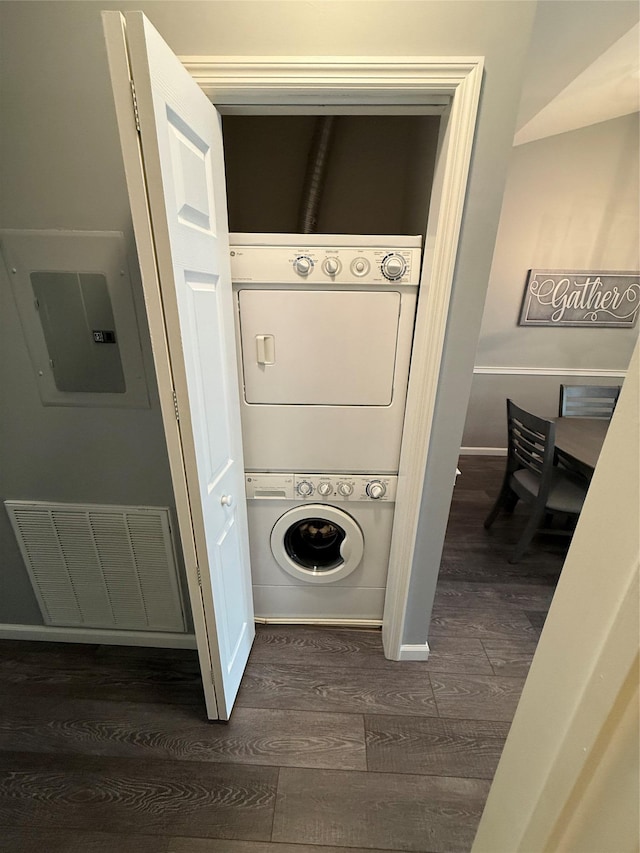 310 Narragansett Villas Dr, Lindenhurst, NY 11757 - laundry room featuring stacked washing machine and dryer, dark wood-type flooring, and electric panel