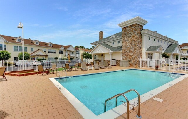 310 Narragansett Villas Dr, Lindenhurst, NY 11757 - community pool featuring a patio, a residential view, and area for grilling
