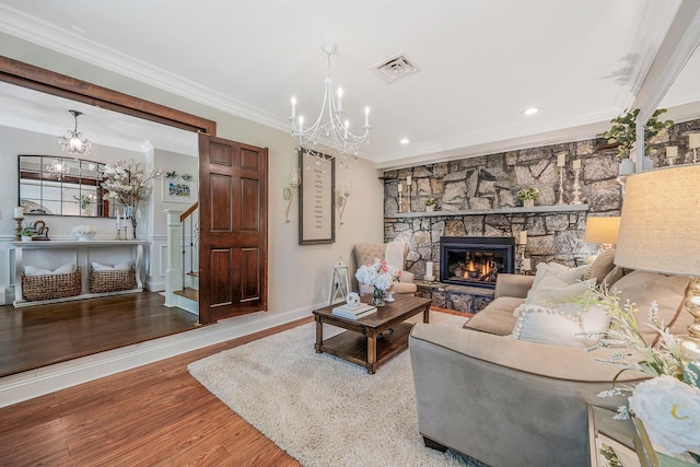 6 Pine St N, Lake Grove, NY 11755 - living room featuring a chandelier, ornamental molding, stairs, wood finished floors, and a fireplace