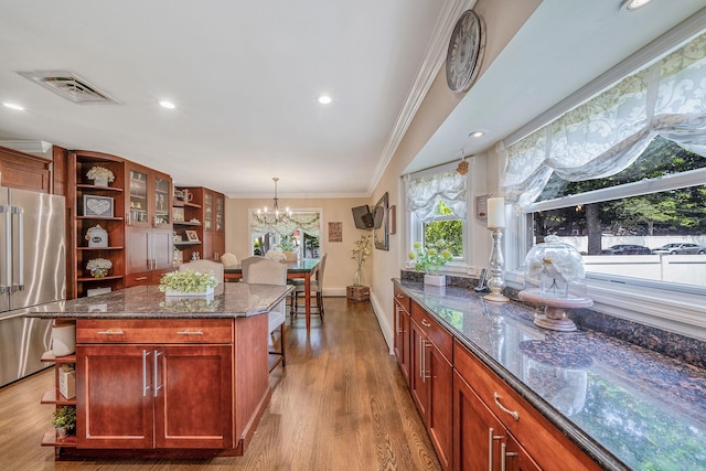 6 Pine St N, Lake Grove, NY 11755 - kitchen featuring open shelves, high end fridge, crown molding, dark stone counters, and healthy amount of natural light