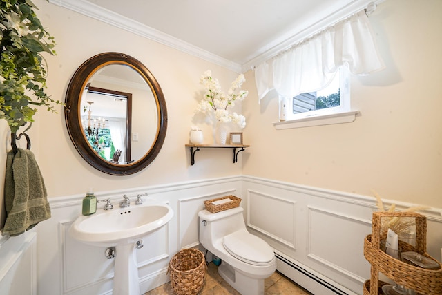 6 Pine St N, Lake Grove, NY 11755 - bathroom featuring baseboard heating, crown molding, wainscoting, a decorative wall, and tile patterned floors