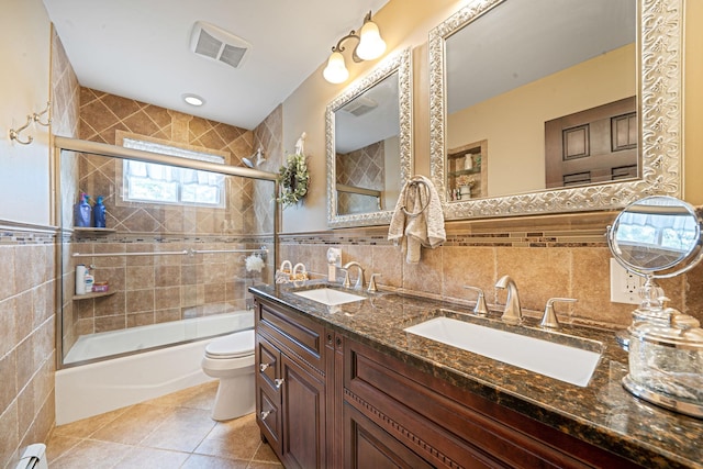 6 Pine St N, Lake Grove, NY 11755 - full bath featuring tile walls, a baseboard heating unit, enclosed tub / shower combo, double vanity, and tile patterned floors