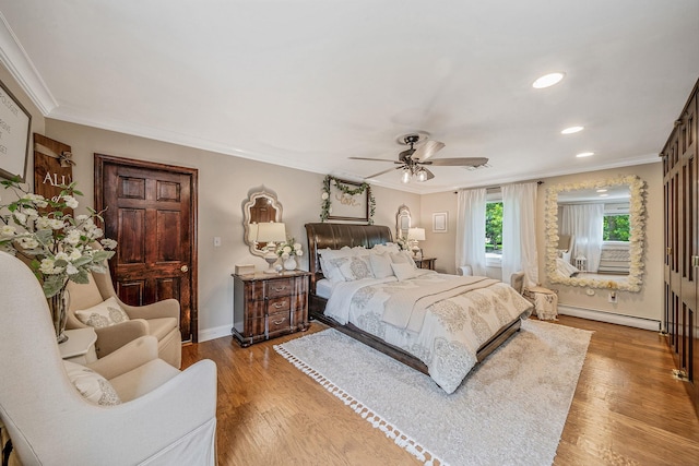 6 Pine St N, Lake Grove, NY 11755 - bedroom featuring baseboard heating, ornamental molding, wood finished floors, ceiling fan, and recessed lighting