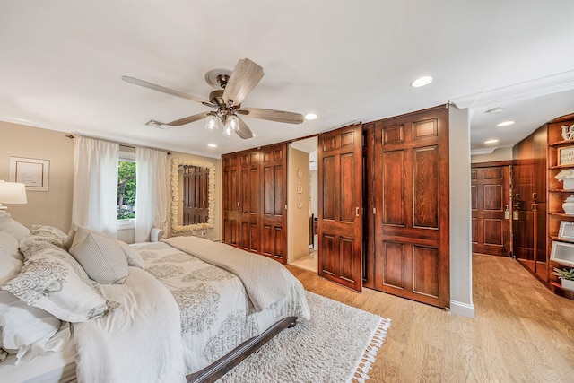 6 Pine St N, Lake Grove, NY 11755 - bedroom featuring light wood-style flooring, recessed lighting, ornamental molding, ceiling fan, and two closets