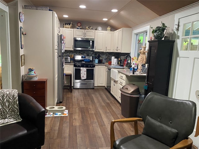 47 E Catskill Trl, Smallwood, NY 12778 - kitchen featuring stainless steel appliances, vaulted ceiling, dark wood-type flooring, white cabinets, and backsplash