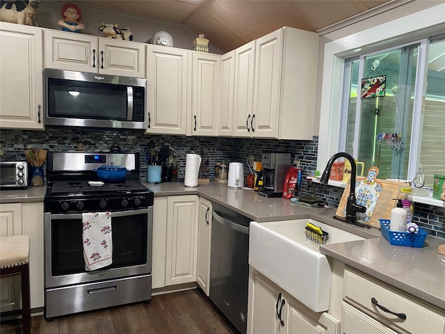 47 E Catskill Trl, Smallwood, NY 12778 - kitchen with appliances with stainless steel finishes, vaulted ceiling, dark wood-style flooring, white cabinets, and decorative backsplash