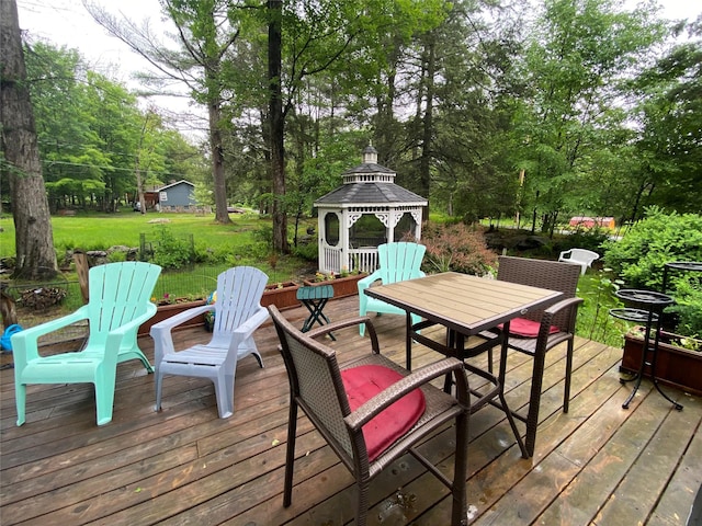 47 E Catskill Trl, Smallwood, NY 12778 - wooden deck featuring a gazebo, outdoor dining area, view of scattered trees, and a lawn