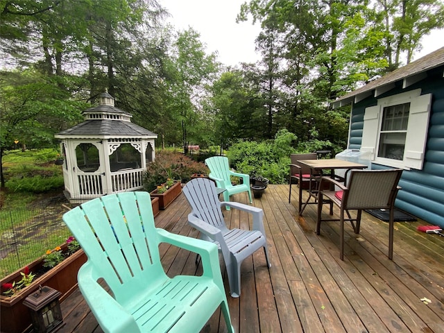 47 E Catskill Trl, Smallwood, NY 12778 - wooden terrace with outdoor dining area, view of wooded area, and a gazebo