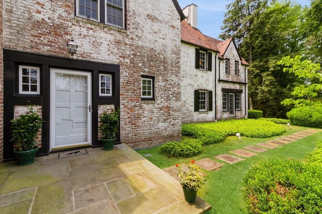 50 Overlook Dr, Chappaqua, NY 10514 - entrance to property featuring brick siding, a chimney, and a high end roof