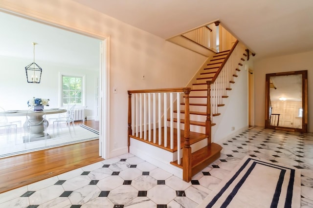 50 Overlook Dr, Chappaqua, NY 10514 - stairway with radiator, a chandelier, and tile patterned floors