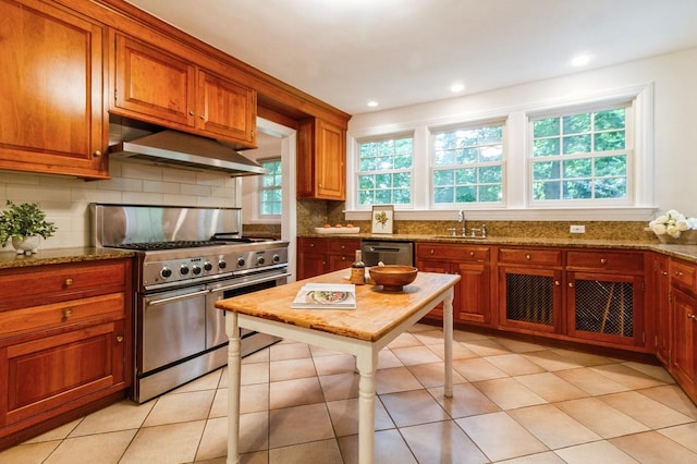 50 Overlook Dr, Chappaqua, NY 10514 - kitchen with stainless steel appliances, exhaust hood, tasteful backsplash, stone counters, and brown cabinets